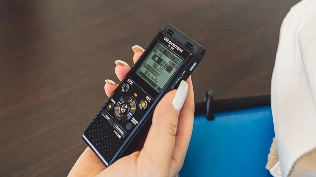OM System WS-883 stereo voice recorder held in hand